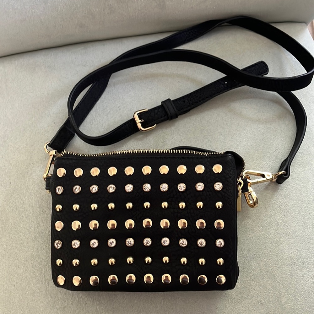 “C” brand. Black studded wristlet with adjustable and removable shoulder strap.